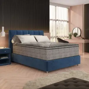 14" Lux Firm Quilted mattress on upholstered blue bed frame in modern bedroom setting with natural light.