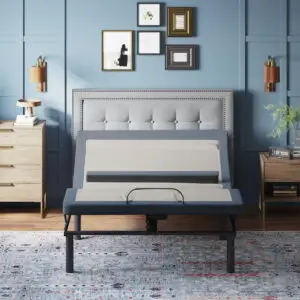 Adjustable bed base in a stylish bedroom setting, showcasing head and foot positioning features, with a modern headboard and bedside furniture.