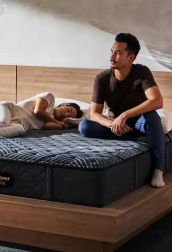 Couple relaxing on Simmons Black mattress, showcasing comfort and quality for better sleep, aligned with Mattress Superstore's offerings.